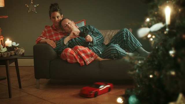 Video Reference: Christmas, Christmas ornament, Christmas tree, Christmas eve, Holiday, Christmas decoration, Christmas lights, Tree, Sitting, Event, Person