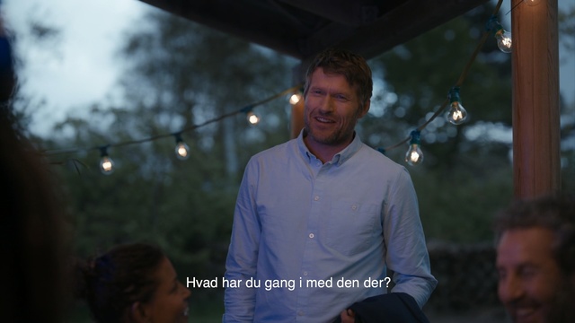 Video Reference: Sky, Tree, Adaptation, Event, Photography, Leisure, Night, Person, Outdoor, Man, Building, Standing, Holding, Front, Looking, Umbrella, Street, Woman, Walking, Table, White, Wearing, Young, Blue, City, People, Shirt, Court, Rain, Phone, Sign, Riding, Field, Ball, Human face, Clothing, Screenshot, Smile