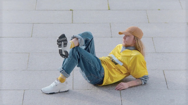 Video Reference: Yellow, Sitting, Footwear, Costume, Jeans, Photography, Shoe, Person, Outdoor, Child, Building, Boy, Young, Little, Sidewalk, Girl, Woman, Small, Holding, Man, Cellphone, Toddler, Wearing, Phone, Standing, Talking, Board, Bench, Hydrant, Fire, Playing, Street, Game, Riding, Ball, Ground, Clothing