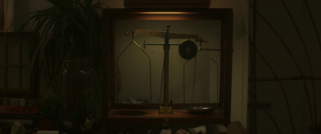 Video Reference: light fixture, darkness, light, lighting, lamp, lighting accessory, interior design, window, ceiling, table, Person