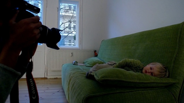 Video Reference: green, mammal, room, furniture, sitting, house, window, couch, girl, sunlight