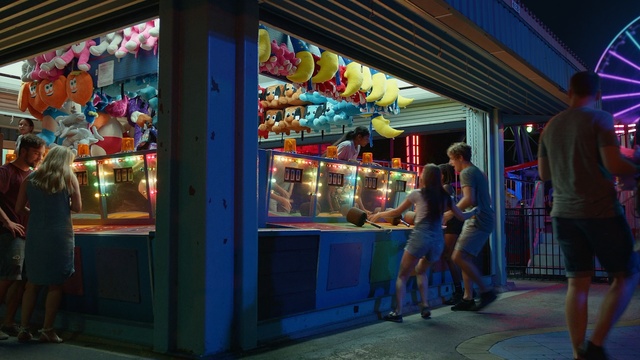 Video Reference: blue, fair, amusement park, fun, night, tourist attraction, city, amusement ride, street, recreation, Person