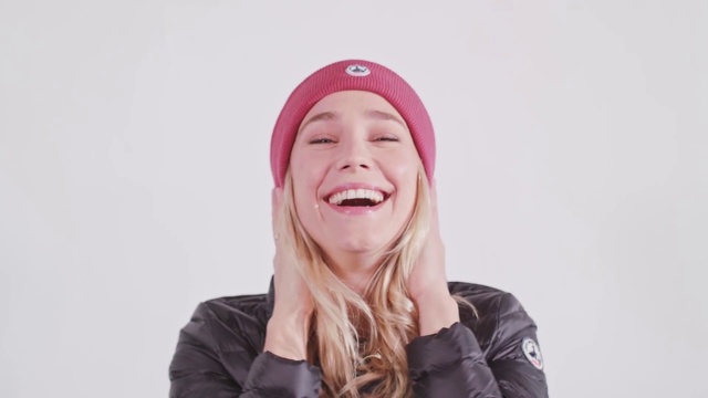 Video Reference: Face, Beanie, Facial expression, Pink, Clothing, Skin, Chin, Lip, Cheek, Forehead