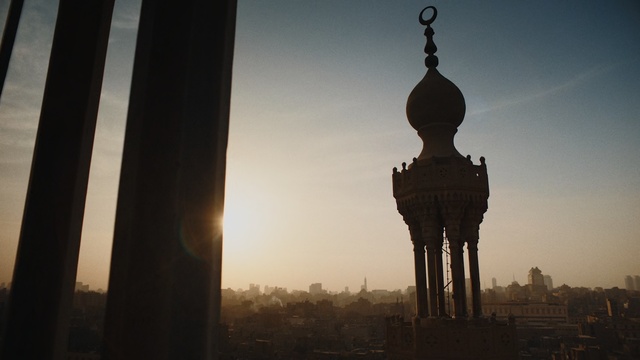 Video Reference: Landmark, Atmospheric phenomenon, Sky, Morning, Tower, Architecture, Sunlight, Photography, Backlighting, Monument, Person