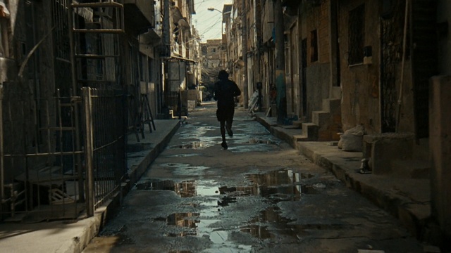 Video Reference: Alley, Street, Road, Infrastructure, Neighbourhood, Darkness, Flooring, Walkway, Nonbuilding structure, Cobblestone, Person