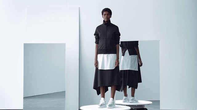 Video Reference: White, Clothing, Standing, Shoulder, Fashion, Joint, Footwear, Knee, Shorts, Outerwear