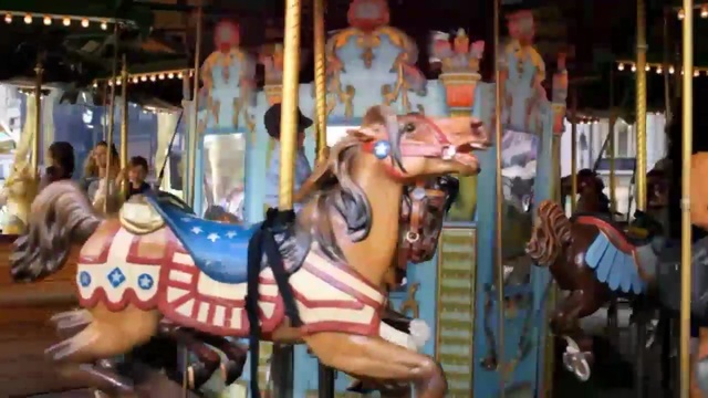 Video Reference: Carousel, Amusement ride, Amusement park, Fun, Recreation, Park, Nonbuilding structure, Fair, Person