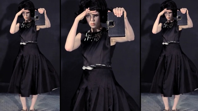 Video Reference: Clothing, Black, Fashion model, Dress, Shoulder, Fashion, Neck, Waist, Little black dress, Collar, Person