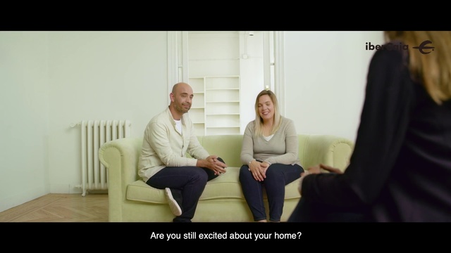 Video Reference: Photograph, Sitting, Snapshot, Conversation, Fun, Interaction, Photography, Photo caption, Adaptation, Room, Person, Indoor, Woman, Man, Looking, Table, Holding, Front, Posing, Young, Living, Using, Smiling, Laptop, White, Standing, Computer, Clothing, Wall, Smile, Human face, Furniture, Text, Couch, Footwear, Jeans