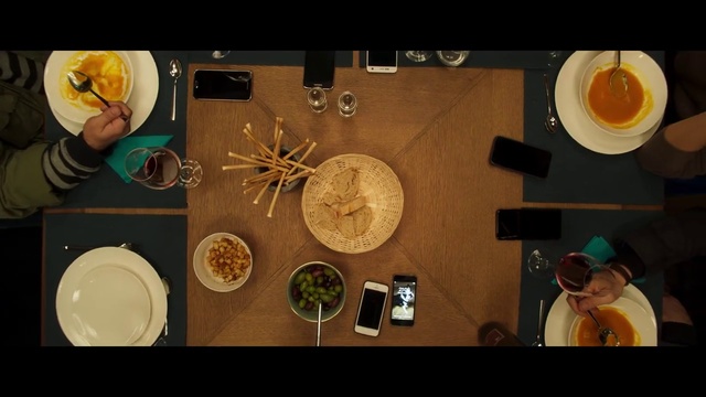 Video Reference: Food, Cuisine, Dish, Comfort food, Person, Indoor, Table, Photo, Items, Sitting, Small, Different, Man, Plate, Various, Several, Holding, Bunch, Wooden, Orange, Many, Room, White, Group, Clock, Screenshot