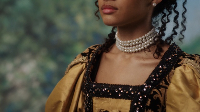 Video Reference: Lady, Beauty, Fashion, Dress, Jewellery, Neck, Fashion design, Necklace, Fashion accessory, Photography, Person, Clothing, Woman, Wearing, Holding, Young, Shirt, Table, Standing, Smiling, Boy, White, Man, Plate, Human face, Crown, Smile, Headpiece