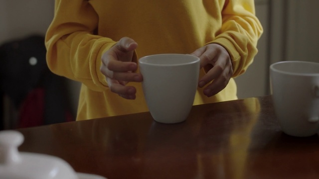 Video Reference: Cup, Cup, Coffee cup, Hand, Drinkware, Drink, Tableware, Table, Teacup, Serveware