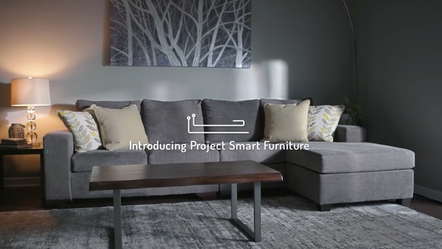 Video Reference: furniture, living room, couch, table, coffee table, loveseat, interior design, wall, sofa bed, floor, Person