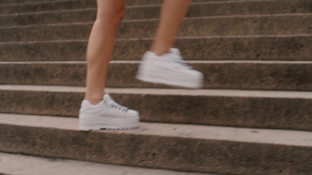 Video Reference: White, Human leg, Leg, Footwear, Shoe, Calf, Ankle, Plimsoll shoe, Stairs, Running