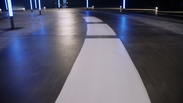 Video Reference: Blue, Floor, Light, Lighting, Flooring, Line, Architecture, Sky, Night, Road surface, Person