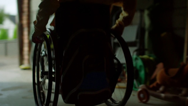Video Reference: Wheelchair, Bicycle wheel, Spoke, Bicycle, Vehicle, Wheel, Bicycle tire, Bicycle accessory, Photography, Disabled sports, Person, Sitting, Table, White, Computer, Laptop, Woman, Man, Dog, Room, Red, Standing, Laying, Street