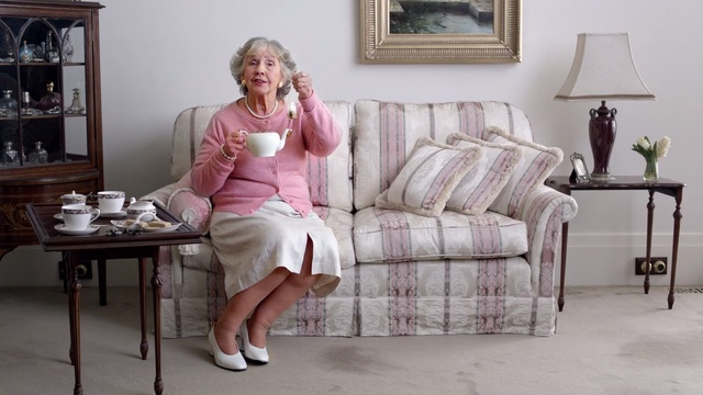 Video Reference: Furniture, Pink, Room, Sitting, Couch, Table, Blond, Leg, Coffee table, Floor, Person