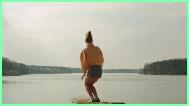 Video Reference: Water, Standing, Summer, Physical fitness, Fun, Vacation, Recreation, Balance, Photography, Stand up paddle surfing, Person, Outdoor, Man, Woman, Board, Holding, Young, Large, Beach, Kite, Flying, Lake, Body, Green, Boat, Surfing, Riding, Clothing, Text, Sky, Nature, Shorts, Shore