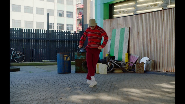 Video Reference: red, infrastructure, public space, standing, urban area, street, road, fun, recreation, house