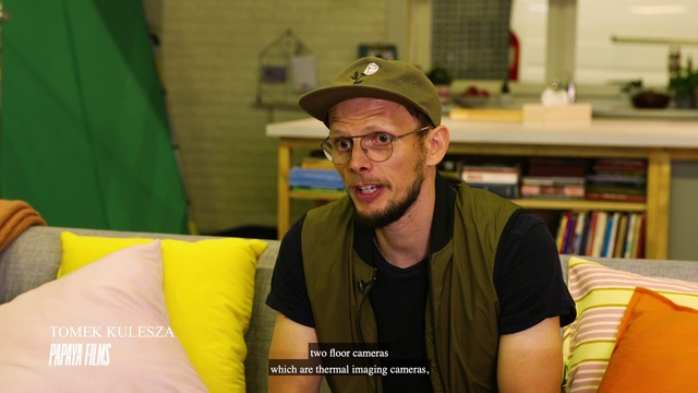 Video Reference: Yellow, Headgear, Glasses, Facial hair, Hat, Furniture, T-shirt