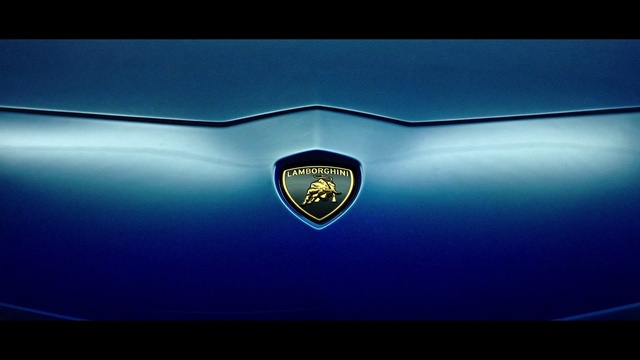 Video Reference: Vehicle, Car, Automotive design, Supercar, Emblem, Lamborghini, Automotive exterior, Sports car, Logo, Electric blue
