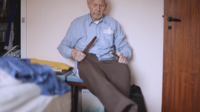 Video Reference: sitting, furniture, leg, arm, senior citizen, shoe, Person