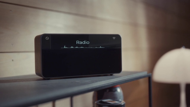 Video Reference: Electronics, Electronic device, Technology, Gadget, Audio equipment, Multimedia, Room, Indoor, Sitting, Table, Black, Kitchen, Computer, Counter, Front, Desk, Laptop, Wooden, Keyboard, Stove, Standing, White, Food, Oven, Phone, Wall, Mobile phone, Screenshot
