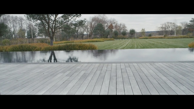 Video Reference: water, tree, roof, grass, walkway, floor, outdoor structure, landscape, land lot, reservoir