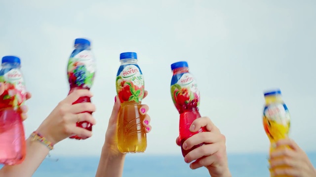 Video Reference: Finger, Nail, Hand, Person, Bottle, Food, Holding, Woman, Man, Water, Table, Small, Drinking, People, Young, Wearing, Glass, Wine, Group, Standing, Red, Dog, White, Playing, Soft drink, Drink, Beverage, Drinking water, Plastic bottle