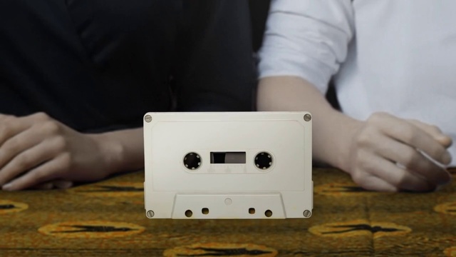 Video Reference: Gadget, Electronic device, Technology, Compact cassette, Electronics, Finger, Hand, Electronics accessory, Power plugs and sockets, Person, Indoor, Laptop, Table, Sitting, Using, Computer, Front, Food, Woman, Cutting, Young, Man, Wooden, Board, Holding, Boy, Large, Kitchen, Pizza, White, People