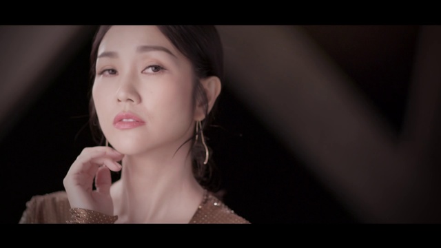 Video Reference: Face, Photograph, Skin, Lip, Beauty, Nose, Head, Chin, Cheek, Eyebrow, Person, Indoor, Woman, Young, Girl, Holding, Looking, Cake, Table, White, Black, Smiling, Wearing, Dress, Shirt, Dark, Standing, Hair, Laptop, Room, Wedding, Red, Plate, Pizza, Human face, Screenshot, Wall, Lipstick, Portrait, Eyelash, Fashion accessory, Necklace, Makeover, Black hair