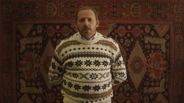 Video Reference: textile, facial hair, outerwear, pattern, material, knitting, art, flooring, Person