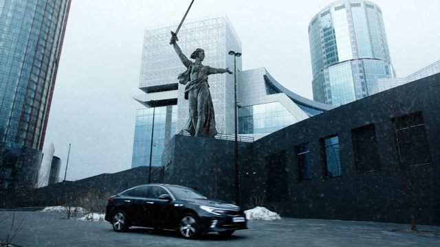 Video Reference: car, building, skyscraper, vehicle, luxury vehicle, facade, Person