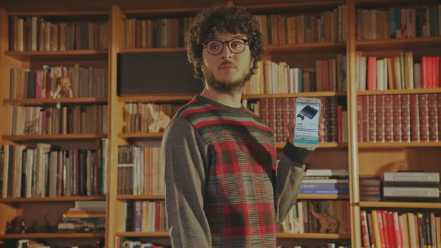 Video Reference: library, librarian, bookselling, bookcase, public library, shelving, book, glasses, facial hair, furniture, Person