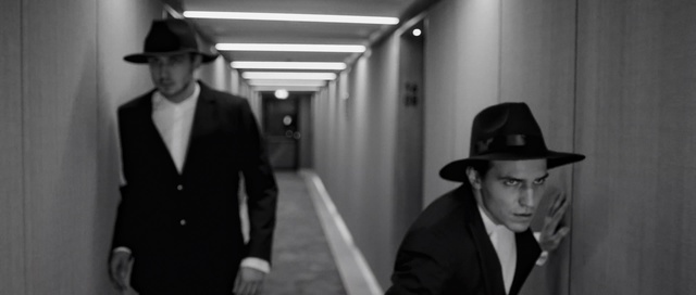 Video Reference: Photograph, White, Suit, Standing, Snapshot, Movie, Film noir, Formal wear, Monochrome photography, Hat