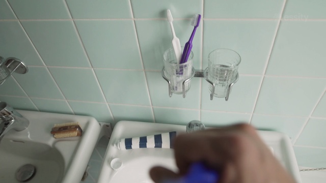 Video Reference: Toothbrush, Purple, Bathroom, Hand, Plumbing fixture, Room, Tile, Brush, Tap