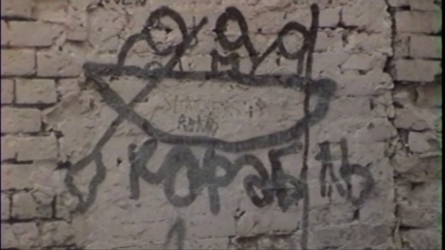 Video Reference: Text, Wall, Art, Font, Graffiti, Street art, History, Handwriting, Ancient history, Stone carving, Person