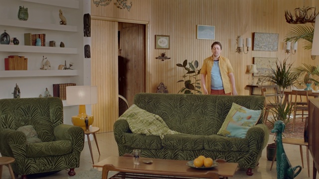 Video Reference: bedroom, room, furniture, interior, sofa, studio couch, bed, home, house, convertible, luxury, lamp, decor, pillow, hotel, living, seat, modern, table, design, floor, comfortable, light, window, sleep, wood, Person