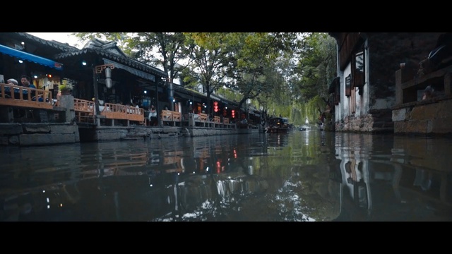 Video Reference: reflection, waterway, water, body of water, town, canal, street, city, tree, evening, Person