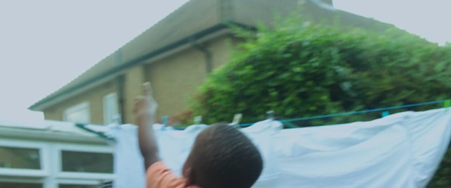 Video Reference: green, plant, property, tree, grass, sky, roof, house, leisure, home, Person