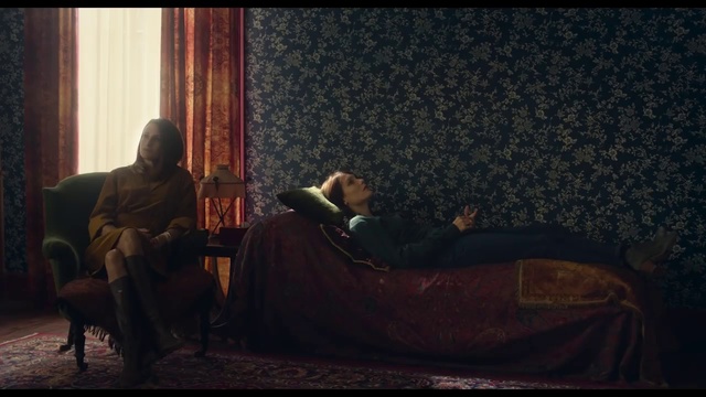 Video Reference: Human, Sitting, Scene, Adaptation, Furniture, Photography, Couch, Screenshot, Conversation, Darkness, Indoor, Laptop, Window, Room, Looking, Bed, Living, Front, Black, Computer, Laying, Man, Open, Dog, Red, Cat, Table, Woman, Suitcase, Sleeping, Person, Clothing, Human face