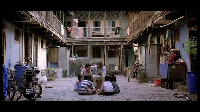 Video Reference: road, street, town, infrastructure, alley, urban area, house, city, window, facade, Person