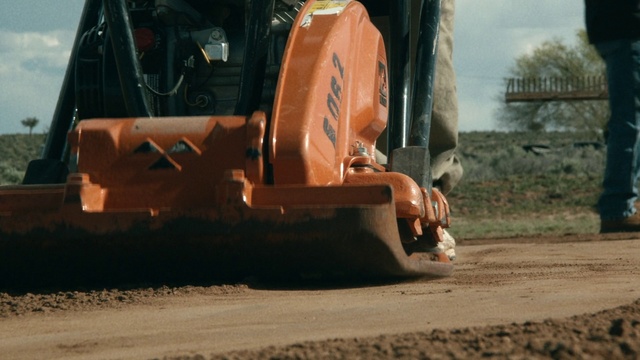 Video Reference: Asphalt, Tree, Vehicle, Soil, Construction equipment, Automotive wheel system, Wheel, Road surface, Bulldozer, Road, Tractor, Car, Sitting, Street, Truck, Old, Brown, Table, White, Mirror, Bus, Large, Man, Train, City, Laying, Motorcycle, Riding, Auto part, Transport, Land vehicle, Power shovel, Tire, Farm machine