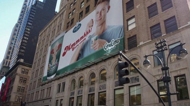 Video Reference: Building, Urban area, Advertising, Architecture, Metropolitan area, Downtown, City, Neighbourhood, Facade, Billboard