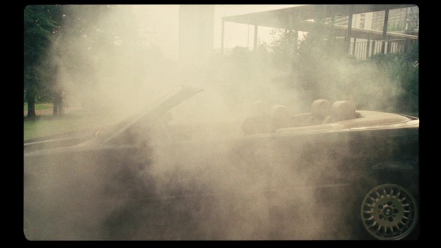 Video Reference: Smoke, Atmospheric phenomenon, Sky, Dust, Vehicle, Atmosphere, Car, Photography, Drifting, Tire, Window, Train, Photo, Monitor, Front, Television, Sitting, Track, Large, Old, Steam, Flat, Black, Engine, White, Screen, Blurry, Kitchen, Man, Oven, Standing, Bus, Fire, Fog, Text, Spring