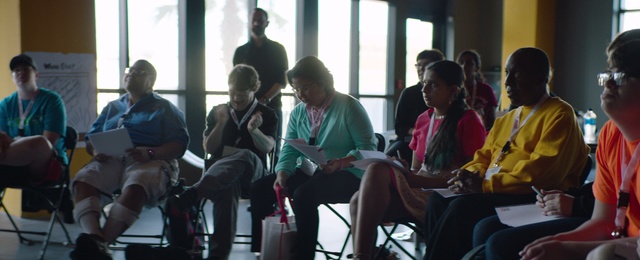 Video Reference: Youth, Community, Event, Adaptation, Sitting, Room, Conversation, Recreation, Crowd, Leisure, Person, Indoor, Window, Group, Table, People, Young, Child, Man, Looking, Computer, Woman, Laptop, Standing, Boy, Girl, Playing, Video, Holding, Riding, Luggage, Living, Wii, Doing, Game, Clothing, Human face