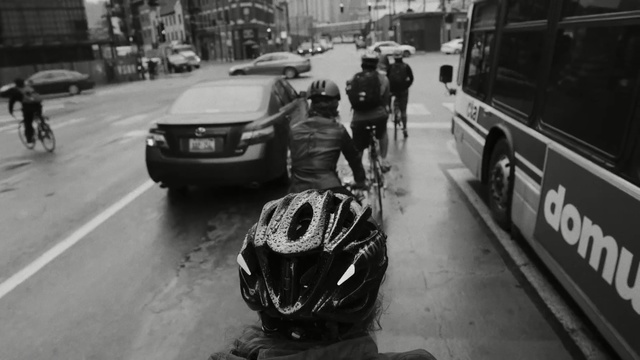 Video Reference: Motor vehicle, Mode of transport, Photograph, Vehicle, Helmet, Transport, Personal protective equipment, Traffic, Lane, Black-and-white, Person