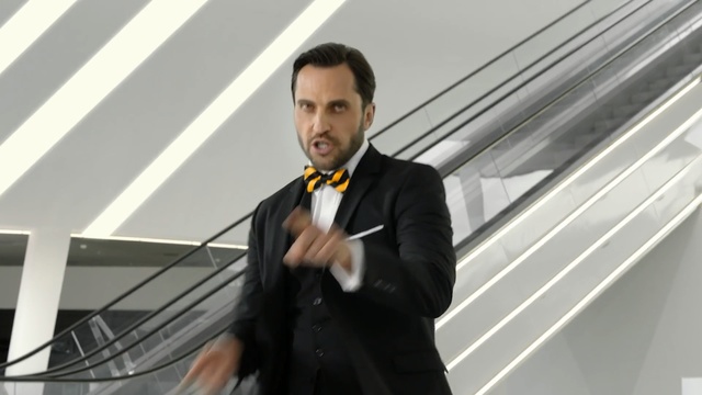 Video Reference: Suit, Formal wear, Gentleman, Tuxedo, White-collar worker, Male, Businessperson, Public speaking, Tie, Outerwear