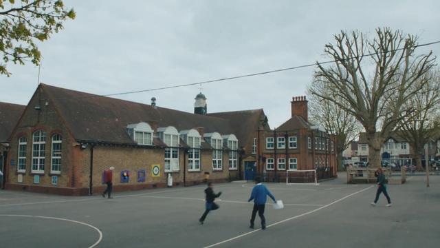 Video Reference: Sport venue, Town, Building, Basketball court, Architecture, Roof, Residential area, City, Team sport, Facade, Person