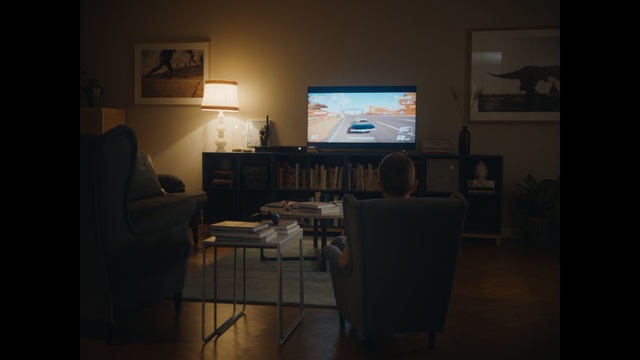 Video Reference: room, furniture, table, home, interior design, living room, darkness, desk, electronic device, multimedia